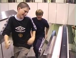 Dominic and Gavin have fun running up the down escalator at Euston station